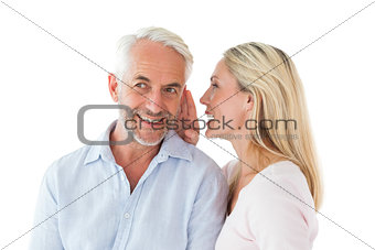 Woman whispering a secret to husband