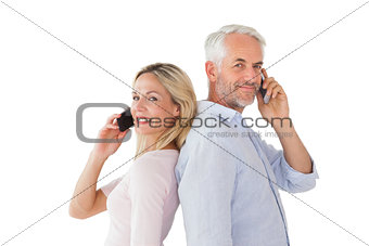 Happy couple talking on their smartphones