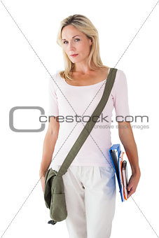 Blonde mature student carrying bag and books