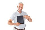 Smiling man pointing to his tablet pc