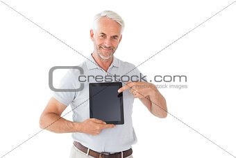 Smiling man pointing to his tablet pc