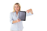 Happy blonde pointing to her tablet pc screen