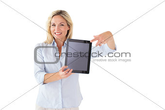 Happy blonde pointing to her tablet pc screen