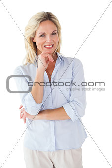 Happy blonde posing with hand on chin
