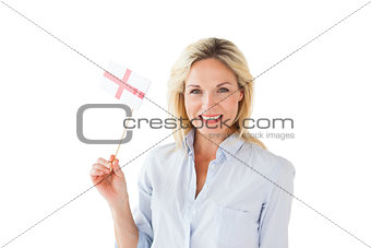 Smiling blonde woman holding english flag