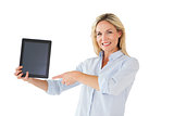 Smiling blonde pointing to her tablet pc