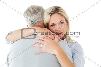 Unhappy blonde hugging her husband