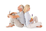Happy couple sitting and holding paintbrushes