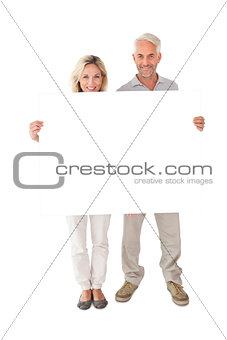Happy couple holding large poster