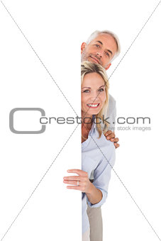 Happy couple showing large poster