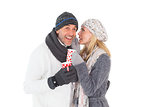 Happy couple in winter fashion holding mugs