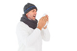 Sick man in winter fashion sneezing
