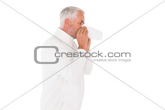 Sick man in winter fashion sneezing