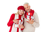 Smiling couple in winter fashion holding presents
