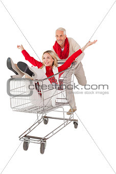 Happy couple messing about in shopping trolley