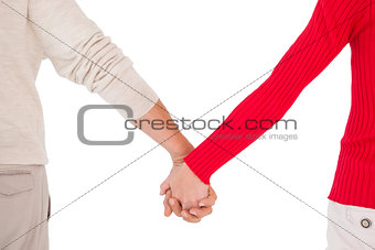 Couple holding hands rear view