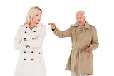 Angry couple fighting in trench coats