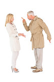 Angry couple fighting in trench coats