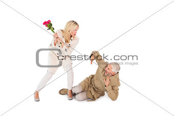 Angry woman attacking partner with rose bouquet