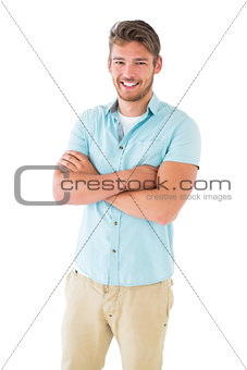 Handsome young man posing with arms crossed