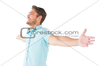 Handsome young man posing with arms out
