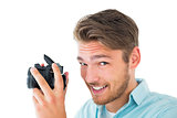 Handsome young man holding digital camera