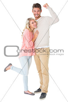 Attractive couple smiling and cheering