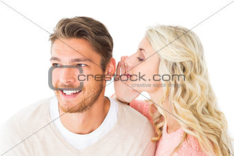 Attractive blonde whispering secret to boyfriend