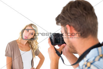 Man taking photo of his girlfriend sticking her tongue out