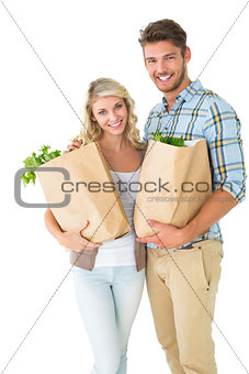 Attractive couple holding their grocery bags