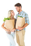 Attractive couple holding their grocery bags
