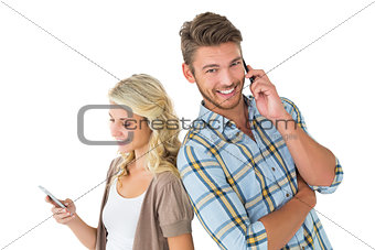 Attractive couple using their smartphones