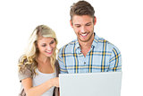 Attractive couple standing and using laptop