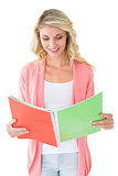 Attractive student reading from notepad