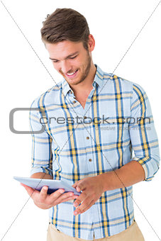 Handsome young man using his tablet pc