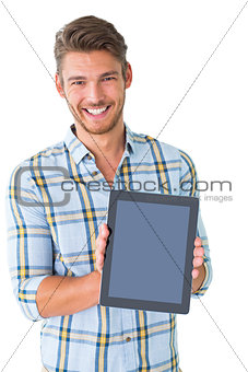 Handsome young man showing his tablet pc