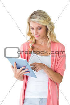 Pretty young blonde using her tablet pc