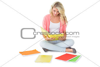 Pretty young blonde sitting and studying