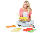 Pretty young blonde sitting and studying
