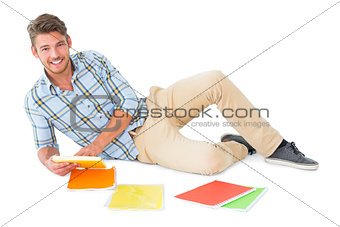 Handsome young man lying and studying