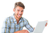 Handsome young man sitting using laptop