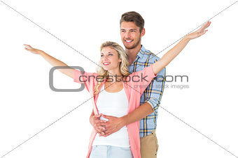 Attractive young couple smiling and embracing