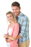 Attractive couple embracing and smiling at camera
