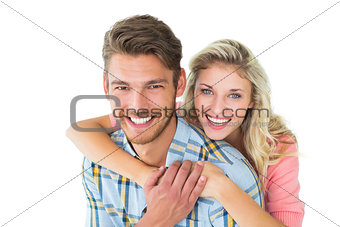 Attractive couple embracing and smiling at camera