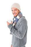 Handsome man in winter fashion holding mug