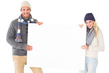 Attractive couple in winter fashion showing poster