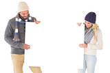 Attractive couple in winter fashion showing poster