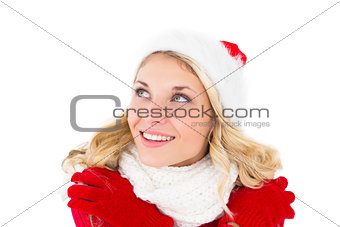 Festive blonde looking up in santa hat