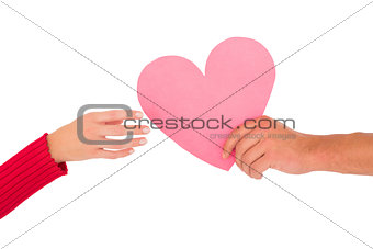 Couple passing a paper heart