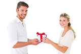 Attractive young couple holding a gift